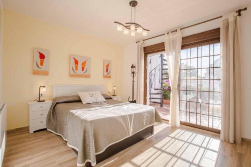 a bedroom with a bed and a large window at BayMar by MarCalma in Montroig