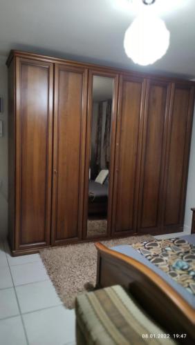a bedroom with wooden cabinets and a bed at Willa Sandal in Eilat
