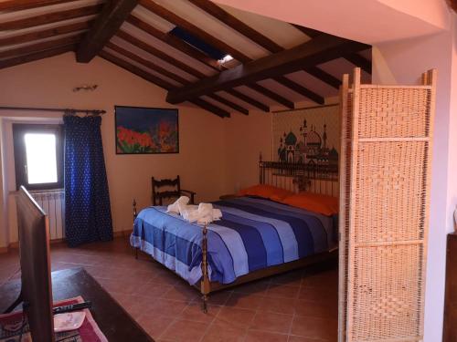 a bedroom with a bed in a room at La mansarda del Sacro Bosco in Bomarzo