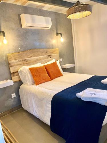 a bedroom with a large bed with orange pillows at Villa Rio by Valada Village in Valada