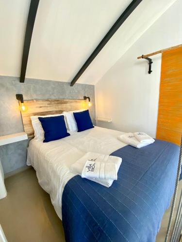 a bedroom with a bed with two towels on it at Villa Rio by Valada Village in Valada