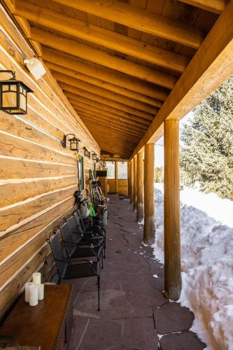 a row of benches on a covered porch with snow at Beyul Retreat in Meredith