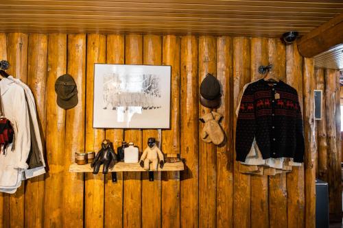a wooden wall with a shelf with clothes and a picture at Beyul Retreat in Meredith