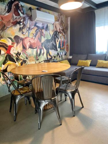 a table and chairs in a room with a mural at Villa Rio by Valada Village in Valada