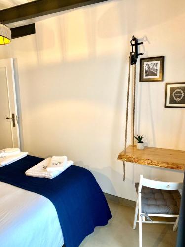 a bedroom with a bed with a blue blanket and a table at Villa Rio by Valada Village in Valada