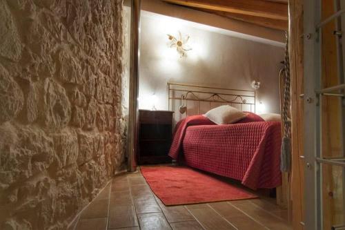a bedroom with a bed with a red blanket at Lilibeth Houses - Charming & Lovely views in Scicli