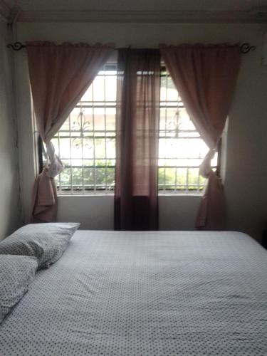 a bedroom with a large bed and a window at Errol and Nancy's Place in Nassau