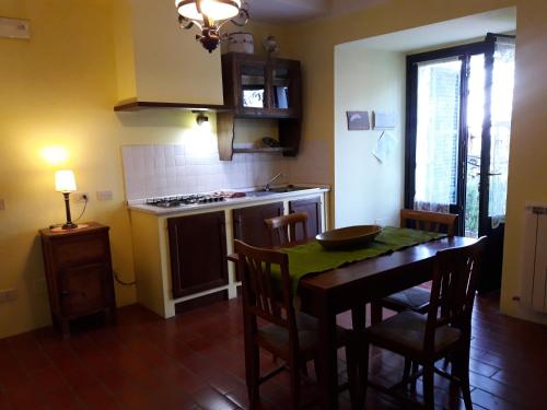 a kitchen with a table and a kitchen with a stove at Ca' le Suore in Cagli