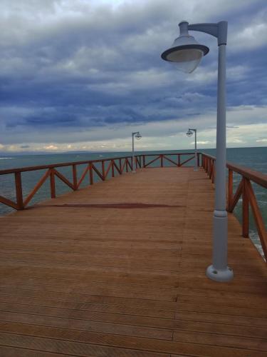 a light pole on a pier with the ocean at Iris 3 in Paralia Katerinis