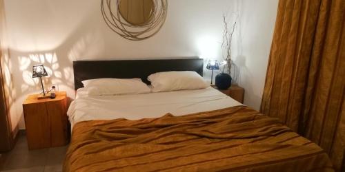 a bedroom with a bed and a mirror on the wall at Iris 3 in Paralia Katerinis
