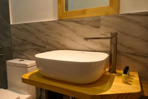 a bathroom with a sink and a toilet at AYIRA Maldives in Feridhoo