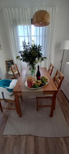 a wooden table with a plate of fruit on it at Casa Nieves de Mario in Santa Cruz de la Palma