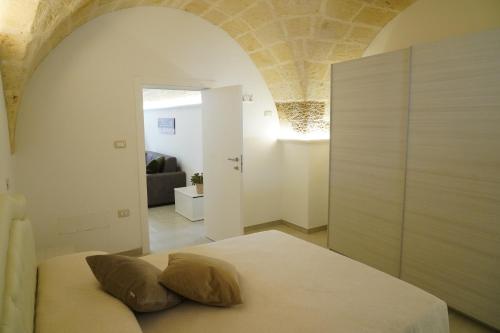 a bedroom with a bed with two pillows on it at La Naca dei Messapi Holiday Home in Mesagne