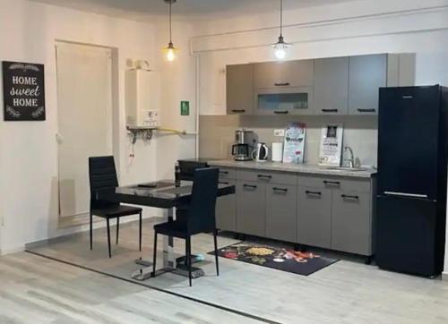 a kitchen with a table and chairs and a refrigerator at Apartament de lux intr-o zona rezidentiala linistita in Iaşi
