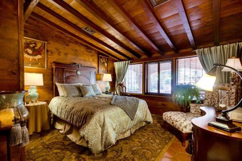 a bedroom with a bed in a room with wooden walls at Vineyard Hacienda in El Cajon