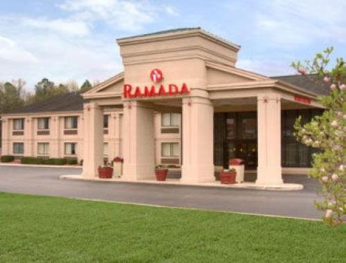a building with a rambala sign in front of it at Ramada by Wyndham Tuscaloosa in Tuscaloosa