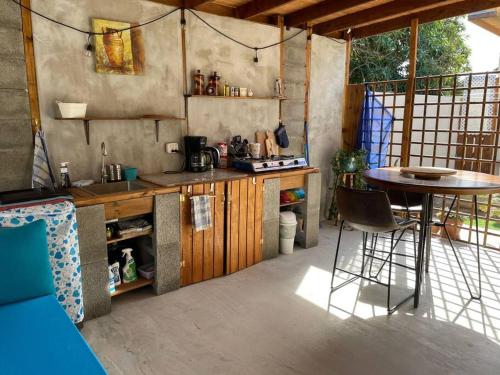 a kitchen with a table and a table and chairs at Studio Urirama with swimmingpool in Noord