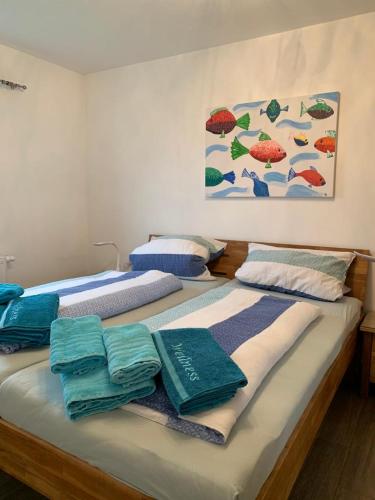 a bedroom with two beds with towels on them at Lieblingsplatz in Kappeln