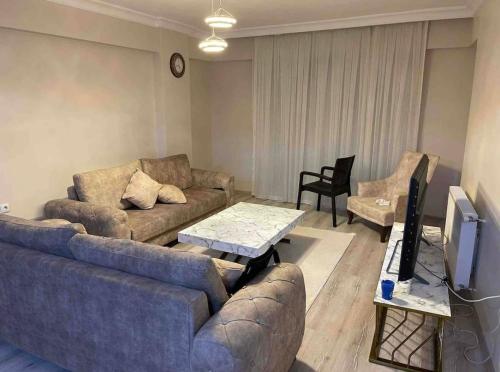 a living room with a couch and a tv at BURSA TELEFERIK 4 1 DUPLEX apartment in Yıldırım