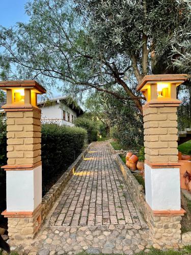a cobblestone street with two lights on top at VoyAca Hotel - Alfareria in Villa de Leyva