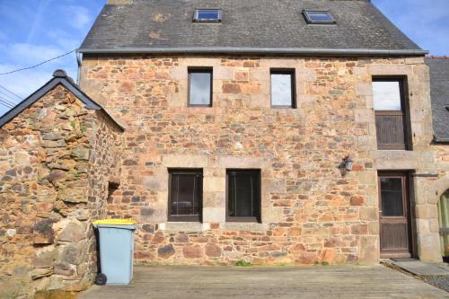 an old brick building with a trash can in front of it at Gite Gloria in Lannion