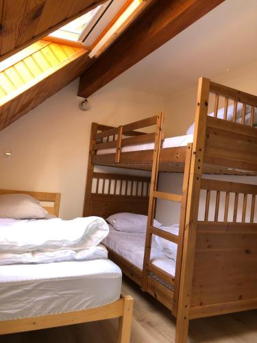 two bunk beds in a dorm room with skylights at Les Badalans in Loudenvielle