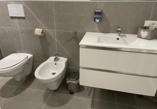 a bathroom with a toilet and a sink and a toilet at B&B m’ama non m’ama in Santeramo in Colle