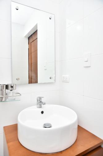 a bathroom with a white sink and a mirror at Apartamento en Juan Dolio Tepuy 501 B in Juan Pedro