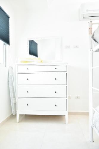 a white dresser in a white bedroom at Apartamento en Juan Dolio Tepuy 501 B in Juan Pedro