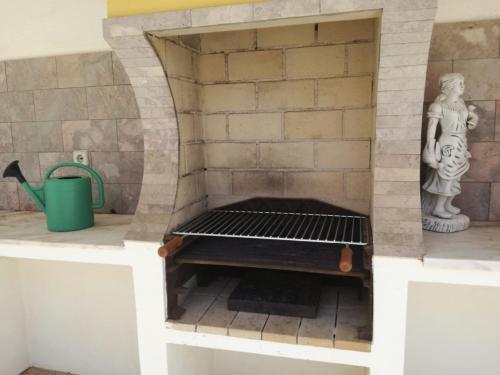 a pizza oven in a kitchen with a brick wall at Casa Oliveirinha - Sagres in Sagres