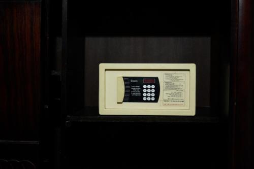 a microwave oven with a remote control in it at Egyptians Hostel in Alexandria