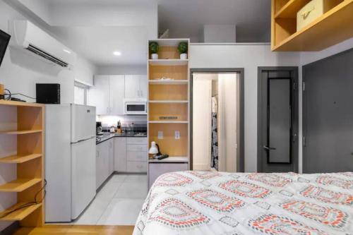 a kitchen and a bedroom with a bed in a room at Small Fully Equipped Contemporary Studio Near MGH in Boston