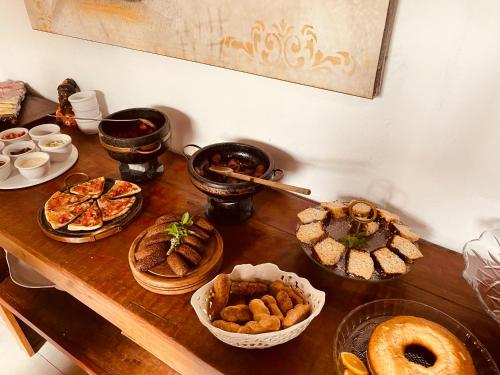 a table with many different types of food on it at POUSADA CHARLOTTE in Tiradentes