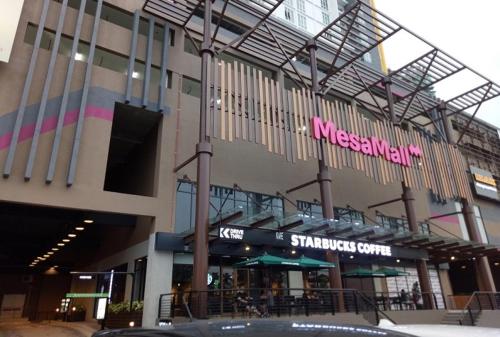 a large building with a pink sign on it at Camellia Mesahill Homestay in Nilai