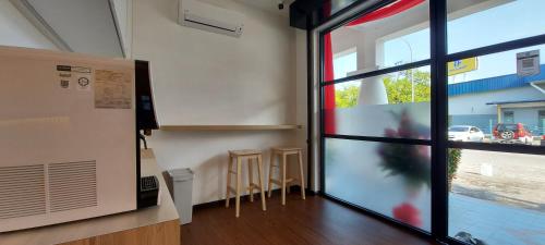 a room with a sliding glass door with a view of a street at Olive Bedz Hotel in Tambun