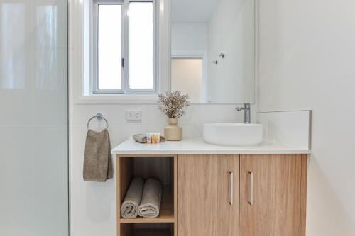 a bathroom with a sink and a mirror at BIG4 Launceston Holiday Park in Launceston