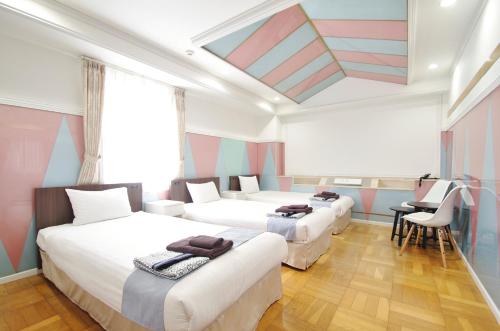 Voodi või voodid majutusasutuse Hotel Imalle Yokohama Isezakicho toas