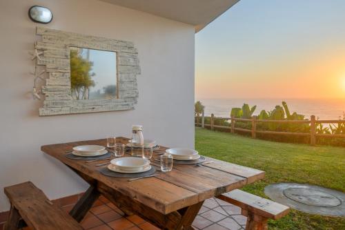 a wooden table with plates and glasses on it at Chakas Cove in Ballito