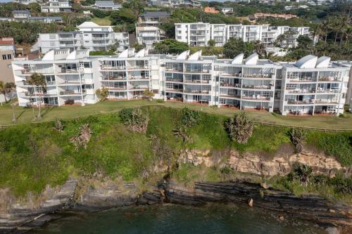 an aerial view of a building on a cliff at Chakas Cove in Ballito