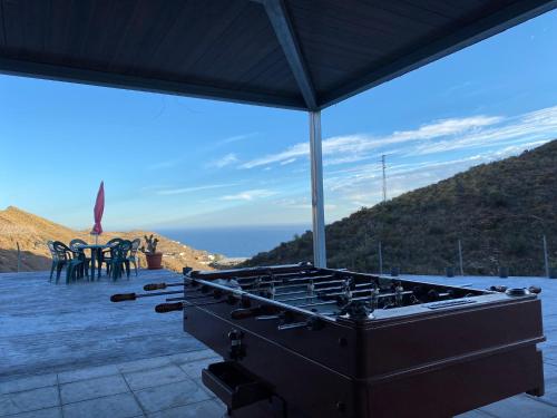 a grill on a patio with a view of the ocean at Casa al sol in Adra