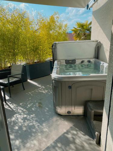 a hot tub sitting on top of a patio at O2M Gresy sur aix in Mognard