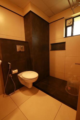 a small bathroom with a toilet and a window at Bonita Banasura in Vythiri