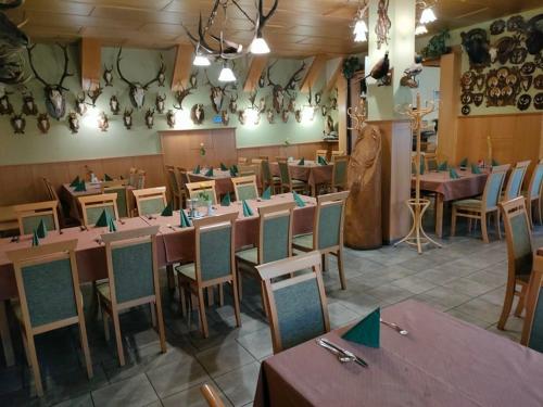 a dining room with tables and chairs in a room at Kisfaludy Vendégház -Sümeg- in Sümeg
