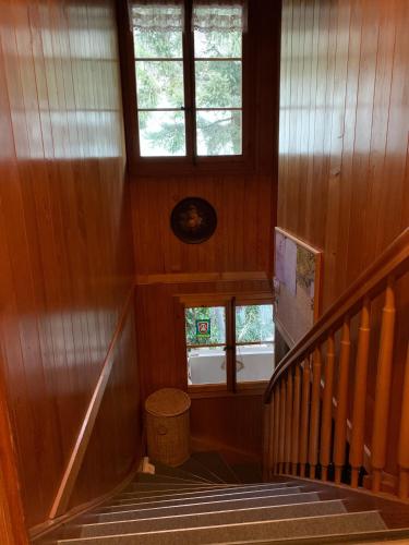 a staircase in a house with two windows at Chalet Rosemarie in Ringgenberg