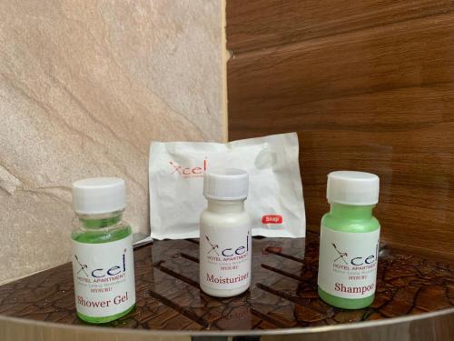 two bottles of medication sitting on a table with a bag at Xcel Luxury Hotel Apartments-Home Living Redefined in Mysore