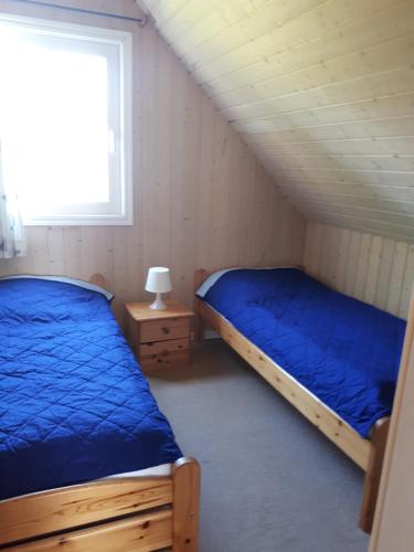 a bedroom with two beds and a window at Marinapark Scharmützelsee in Wendisch Rietz