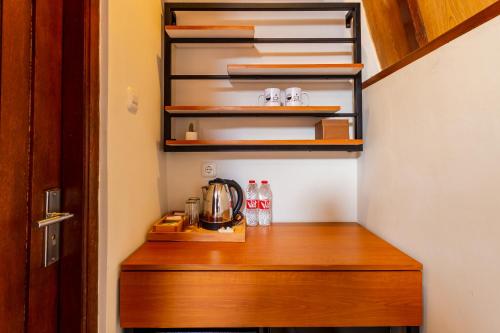 a kitchen with a wooden counter with a coffee maker at Omah Lumbung Yogyakarta in Seturan