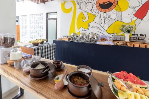 a buffet with food on a wooden table at Omah Lumbung Yogyakarta in Seturan