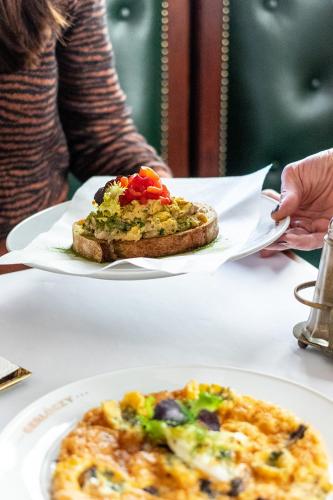 two plates of food on a table with a slice of bread at Gerlóczy Boutique Hotel in Budapest