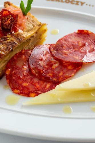 a plate of food with meat and cheese on it at Gerlóczy Boutique Hotel in Budapest